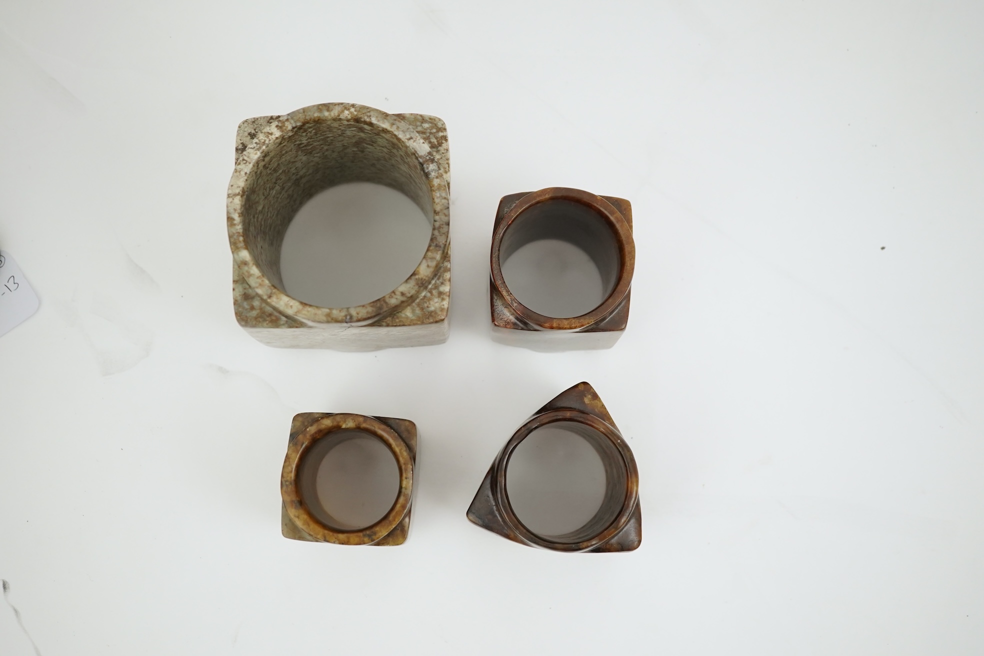 Four Chinese archaistic jade or hardstone cong
